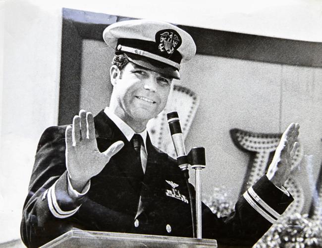 Man in military uniform giving a speech at a podium.