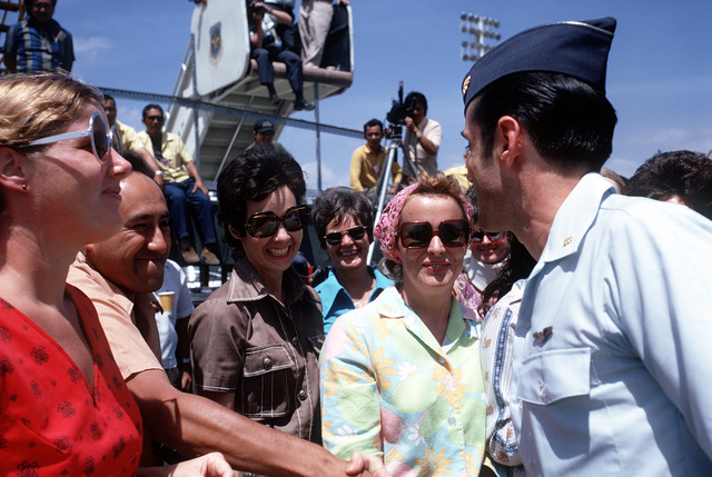 Man in U.S. Air force uniform shaking hands in front of a crowd.