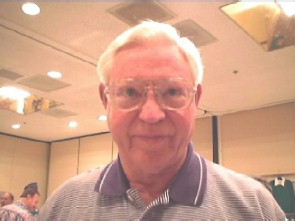 Older man in a collared shirt and glasses.