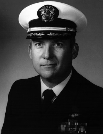 Man in a decorated U.S. Navy suit and cap.