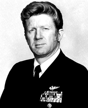 Man in a decorated U.S. Navy suit.