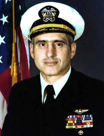 Man in a decorated U.S. Navy suit and cap.