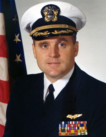 Man in a decorated U.S. Navy suit and cap.