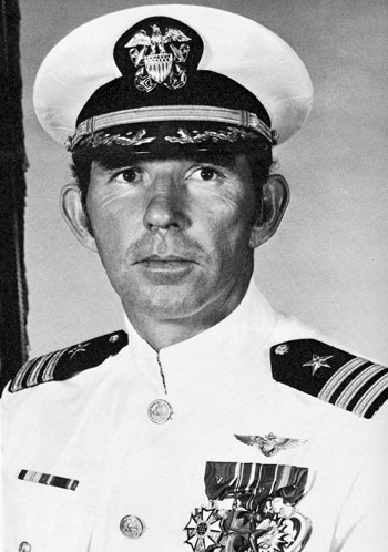 Man in a decorated U.S. Navy suit and cap.