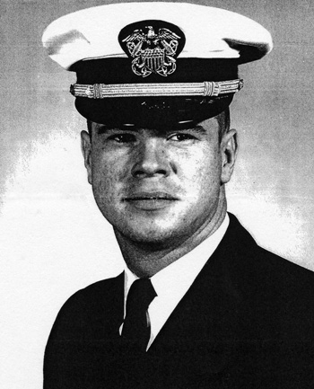 Man in a decorated U.S. Navy suit and cap.