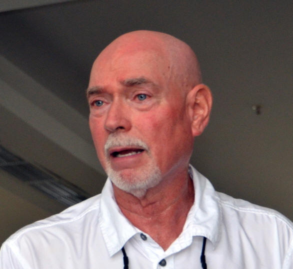 Man in a white collared shirt.