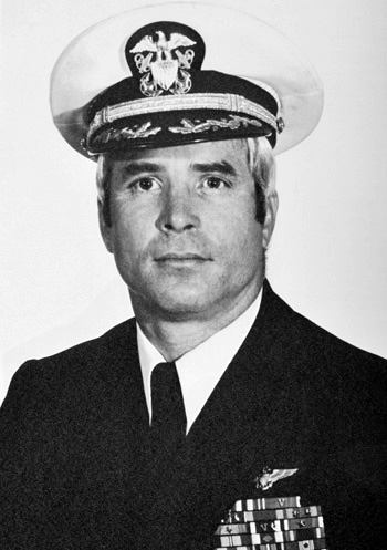 Man in a decorated U.S. Navy suit and cap.