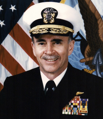 Man in a decorated U.S. Navy suit and cap.