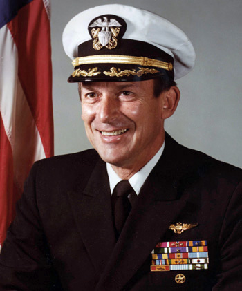 Man in a decorated U.S. Navy suit and cap.