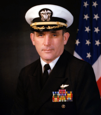 Man in a decorated U.S. Navy suit and cap.