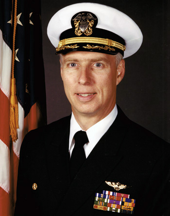 Man in a decorated U.S. Navy suit and cap.