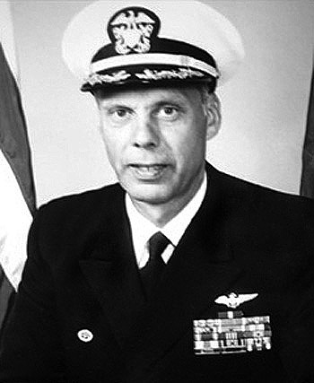 Man in a decorated U.S. Navy suit and cap.