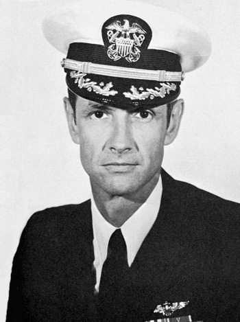 Man in a decorated U.S. Navy suit and cap.