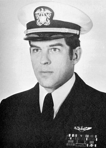 Man in a decorated U.S. Navy suit and cap.