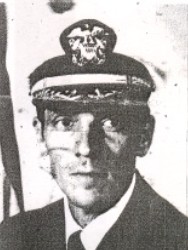 Man in a decorated U.S. Navy suit and cap.