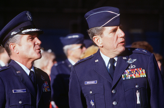 Two military officers in decorated suits and caps.