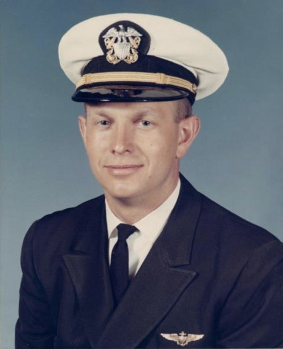 Man in a decorated U.S. Navy suit and cap.