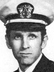 Man in a suit and tie and U.S. Navy cap.