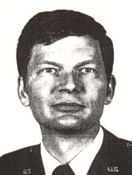 Close up black and white photograph of a man in a suit and tie.