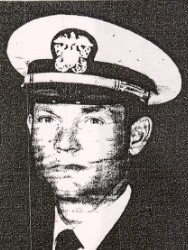 Man in a suit and tie and U.S. Navy cap.