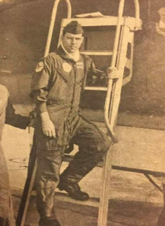 Man standing on ladder of aircraft.