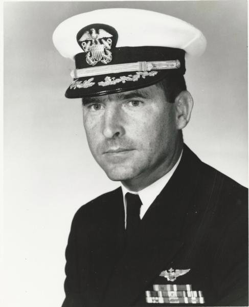 Man in a decorated U.S. Navy suit.