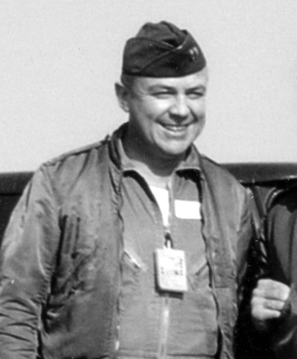 Man in a jacket and military cap.